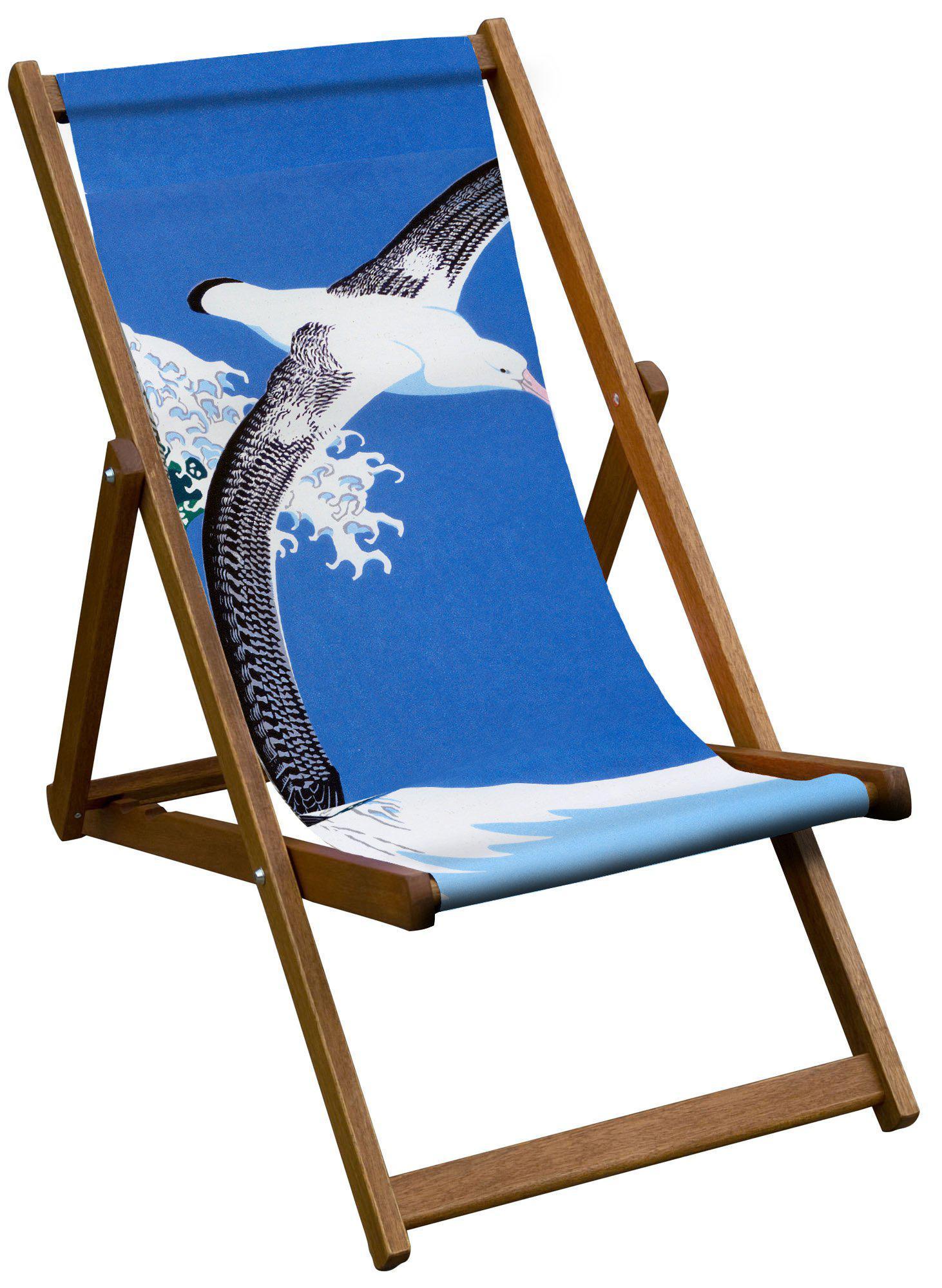 A deckchair featuring an albatross flying in front of a clear blue sky.