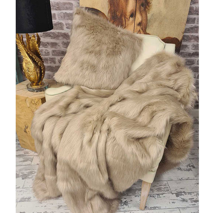 Camel faux fur throw in light beige oatmeal brown draped on a chair with optional matching cushion