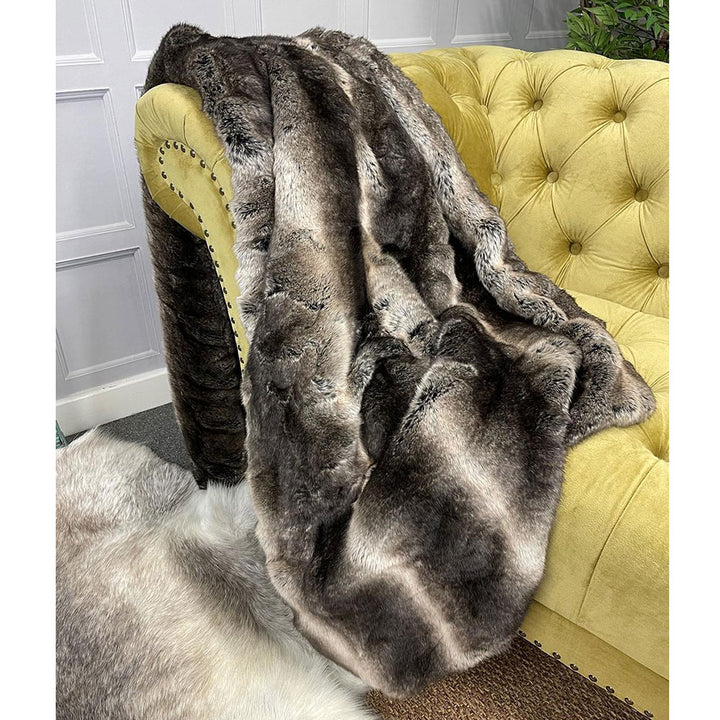 dark chinchilla faux fur throw folded on sofa