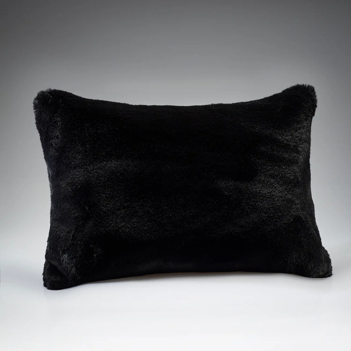 Soft Black rectangular faux fur cushion by Katrina Hampton, shown against a grey background