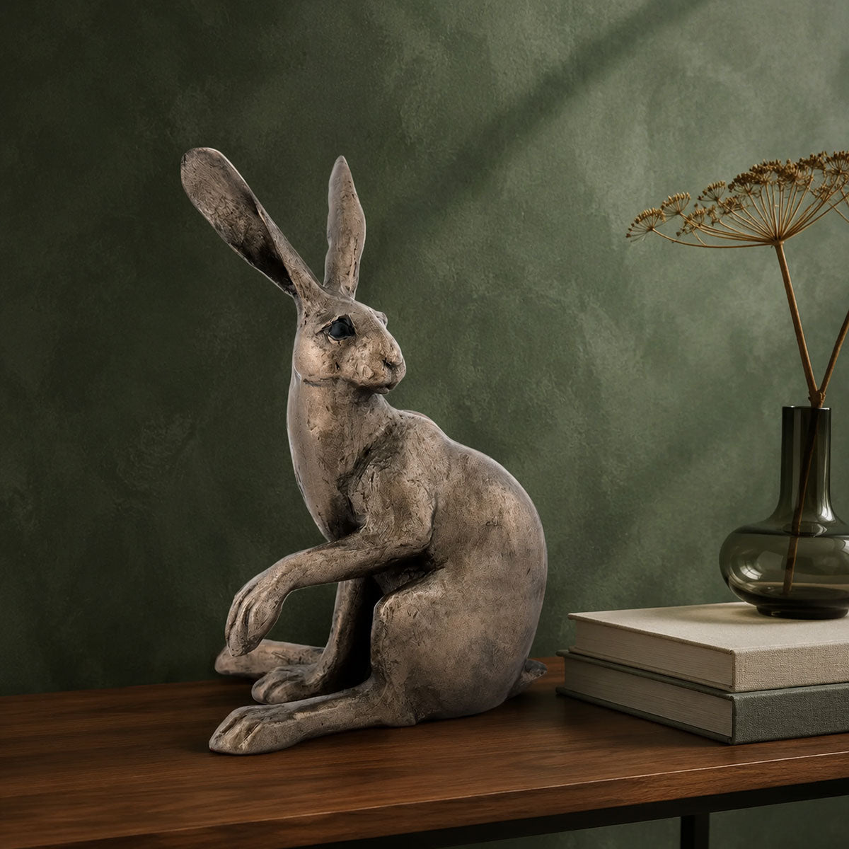 Hattie Hare bronze sculpture displayed on a walnut console against a sage-green wall