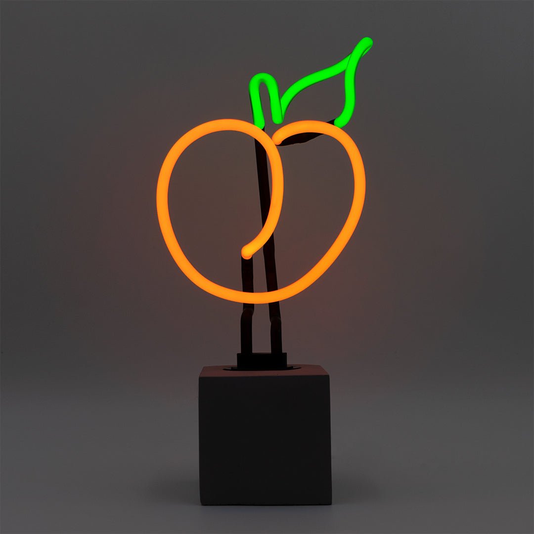 Neon Peach Sign product image shown in a home or gift setting