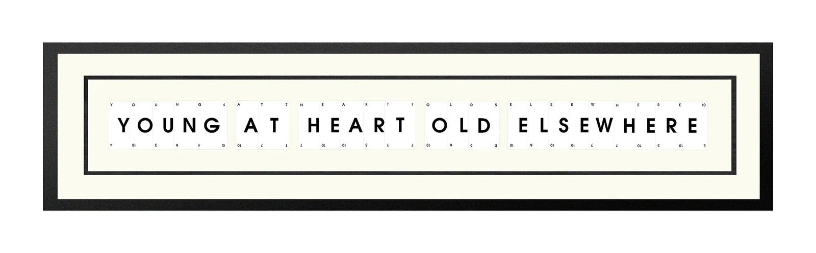 Handmade playing card picture frame spelling 'Young At Heart Old Elsewhere' – framed quote wall art made in the UK.